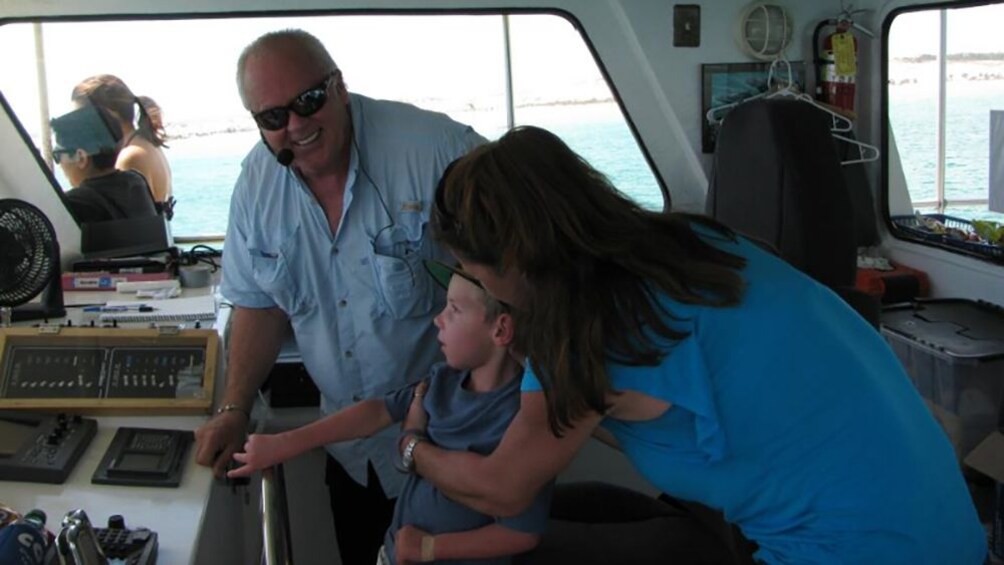 Show item 3 of 8. Captain lets kid drive ship.