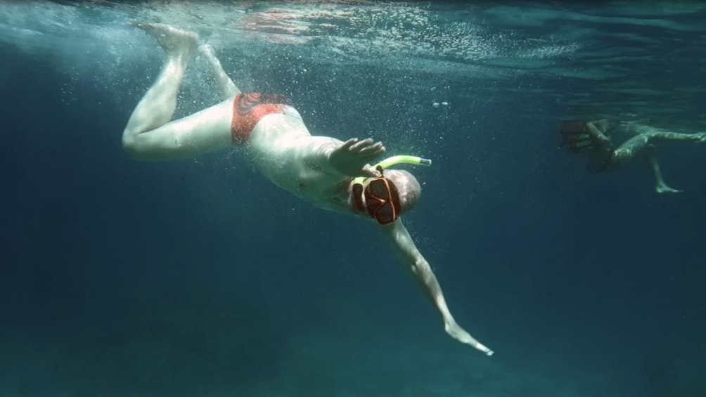 Man snorkeling underwater.