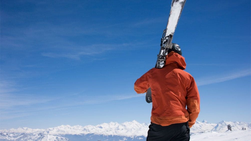 Skier holding skis on a mountain in Salt Lake City