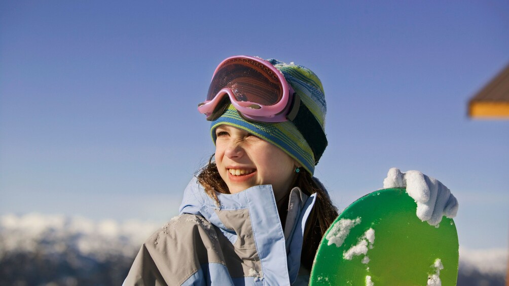 Young girl with snowboard in Salt Lake City