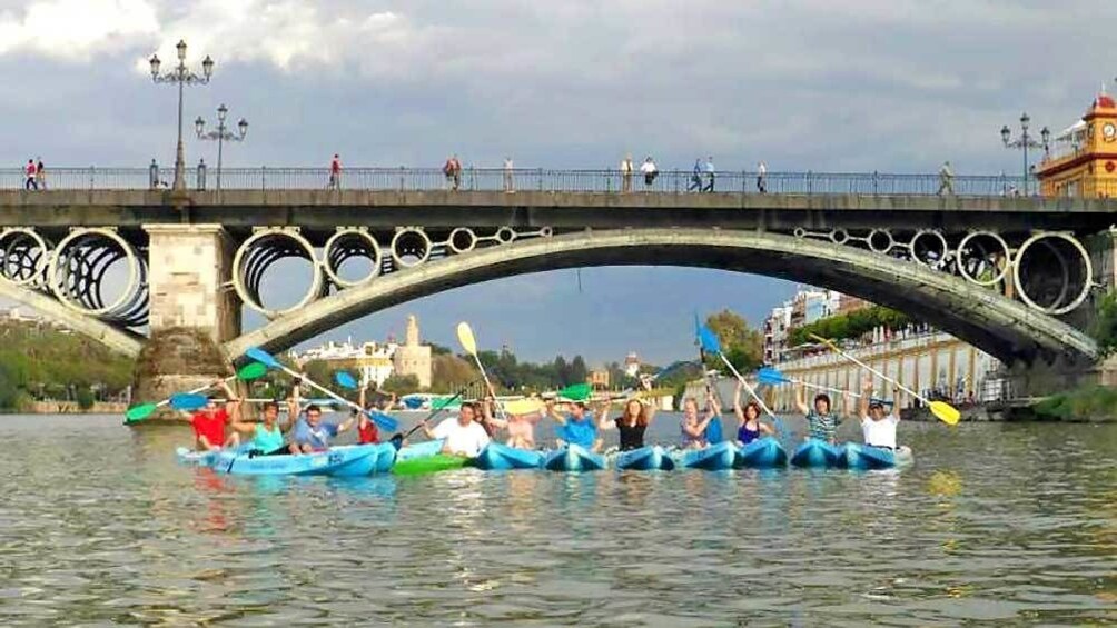 group of kayakers under a bridge in Spain