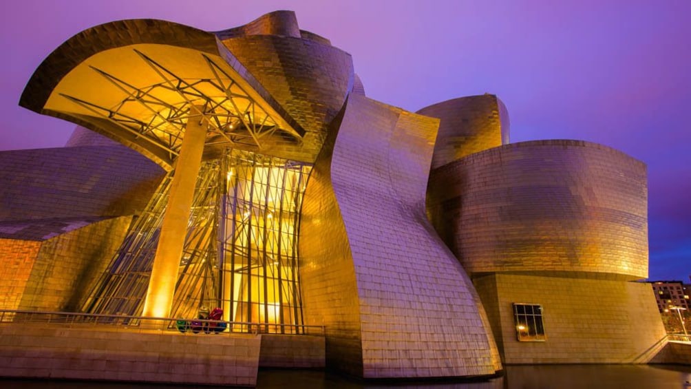 The Guggenheim Museum illuminated at night.