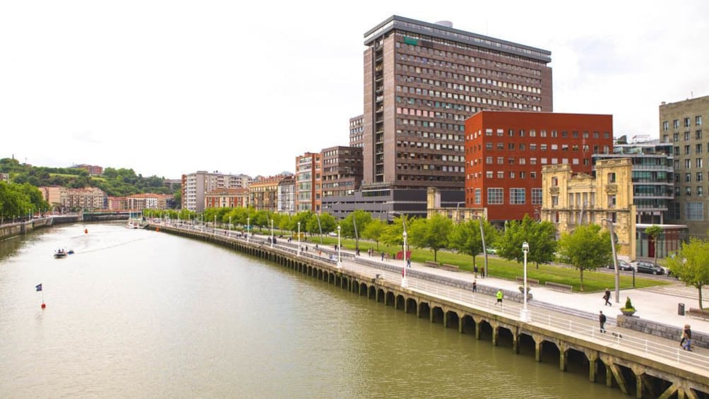 View of river with city buildings in the distance.