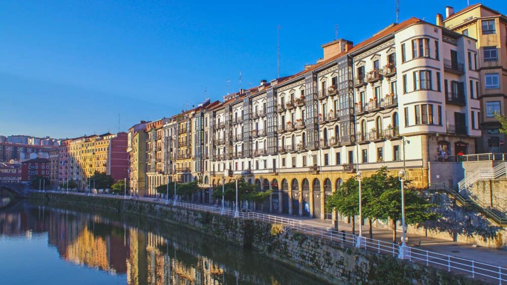 Angled view of river with several buildings in the distance.