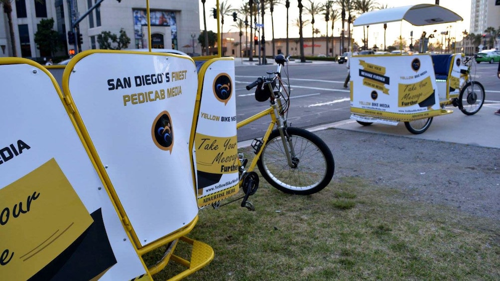Pair of pedicabs parked along the street in San Diego