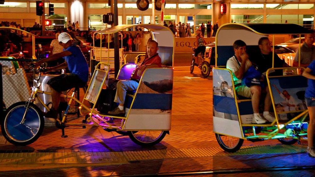 busy street filled with taxi bikes in San Diego