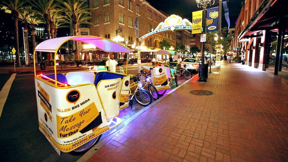 bike taxi service at the side of the road at night in San Diego