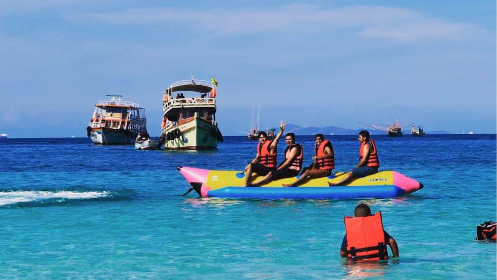 Show item 1 of 5. People on a watercraft on Coral Island