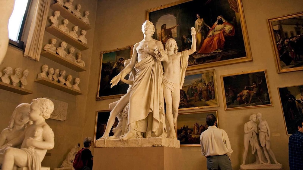 marble sculptures surrounded by paintings in Florence