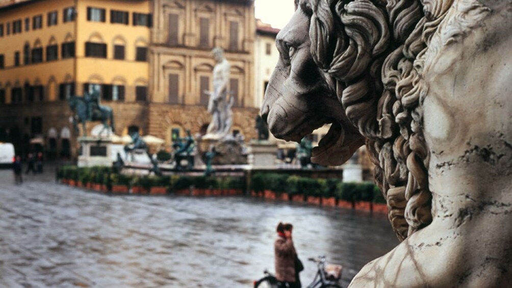 Close up of lion sculpture in courtyard.