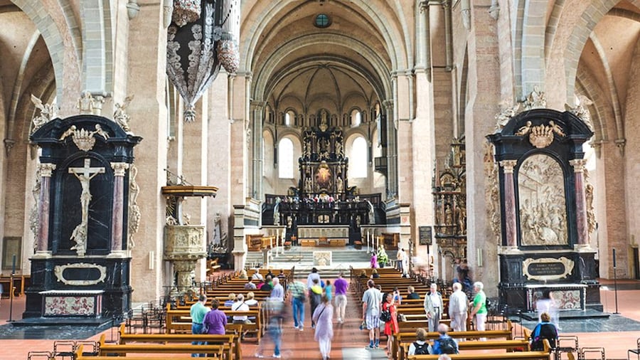 Interior view of cathedral with several people inside.