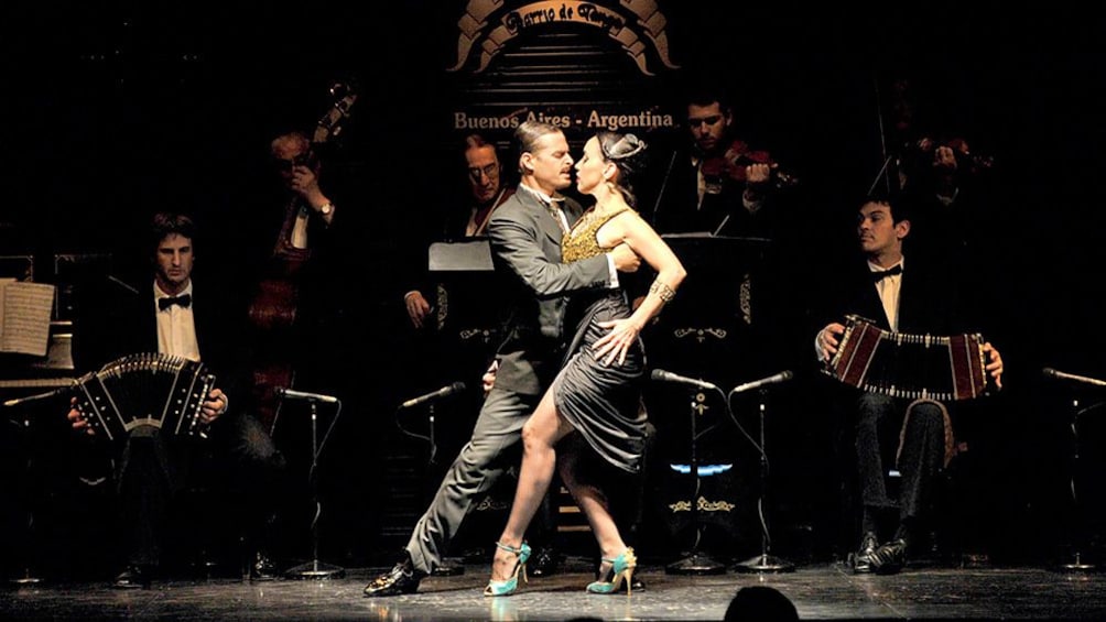man and woman dancing on stage with live music in Argentina