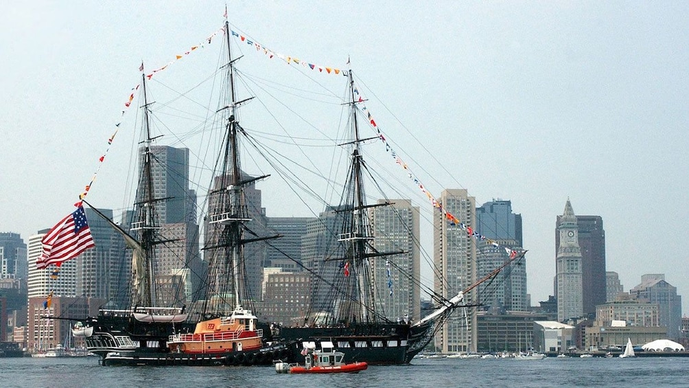 a large wooden ship with hanging flags in Boston