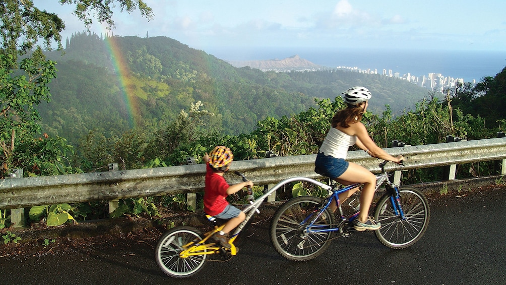 Mother and child bicycling in the hills on Oahu