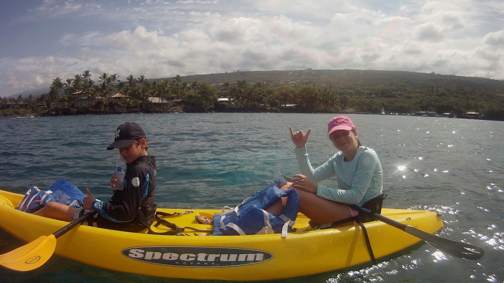 Kayaker gives hand sign to camera at Big Island