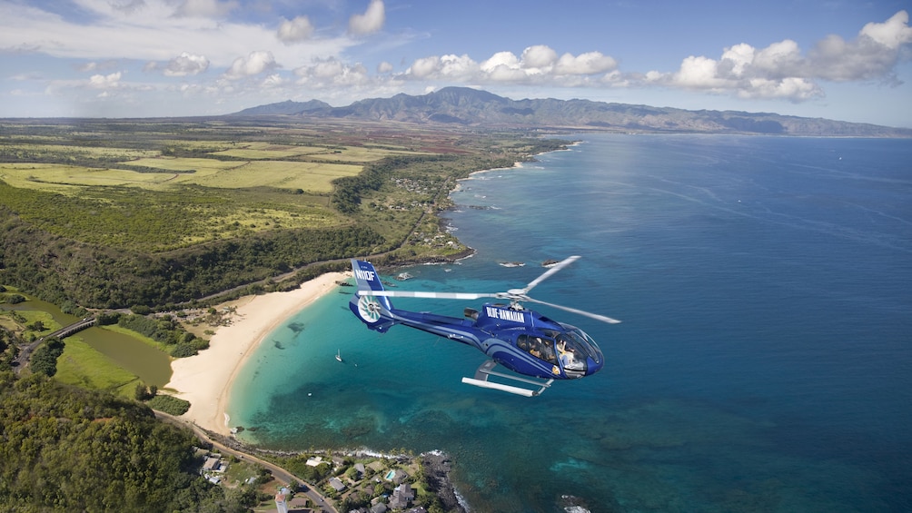 Show item 5 of 9. Aerial view of helicopter over Ocean
