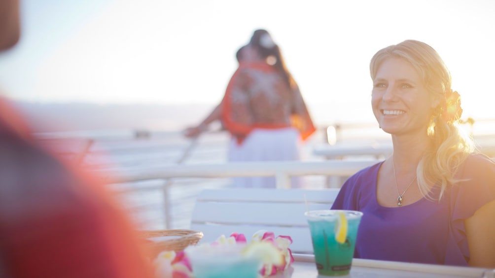 Show item 2 of 8. Couple with drinks on the Sunset Dinner Cruise in Maui