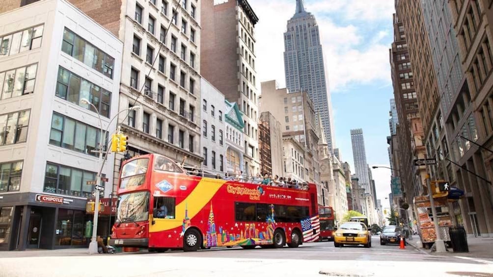 Show item 2 of 9. a double decker bus navigating the city of New York