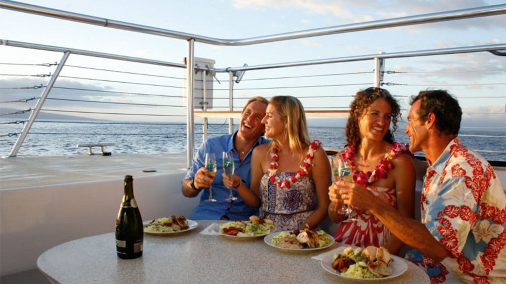 Dining group on a sailboat at sunset on Maui