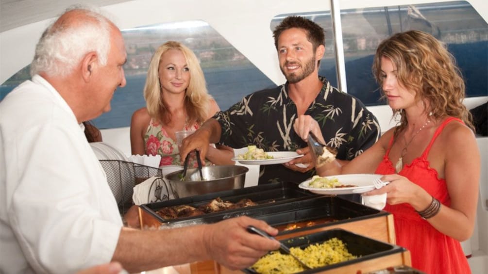 Group at a dinner buffet on a sailboat on Maui
