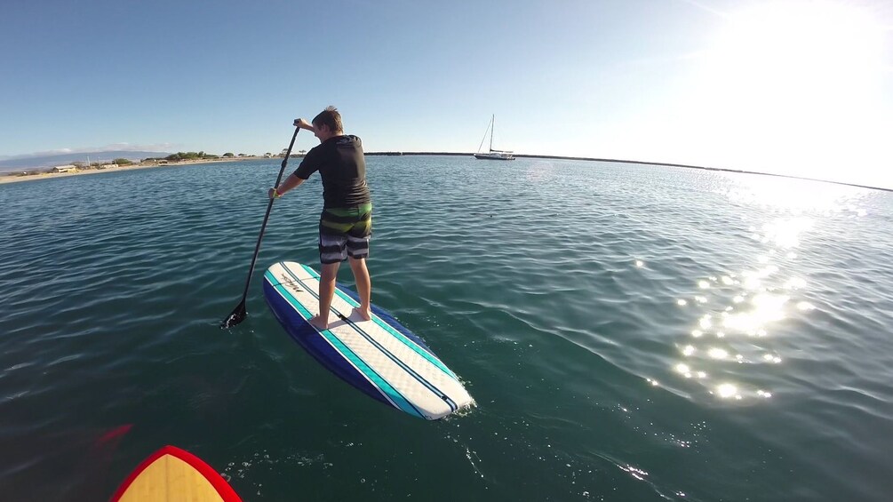man on paddleboard in Hawaii