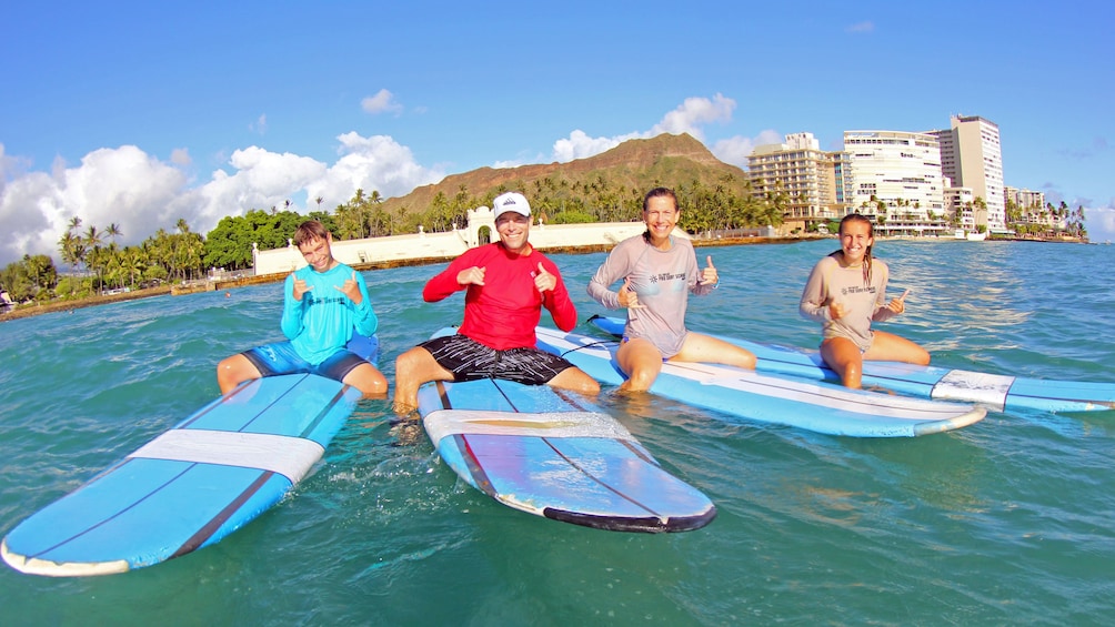 Show item 1 of 3. Family on surf boards in Oahu