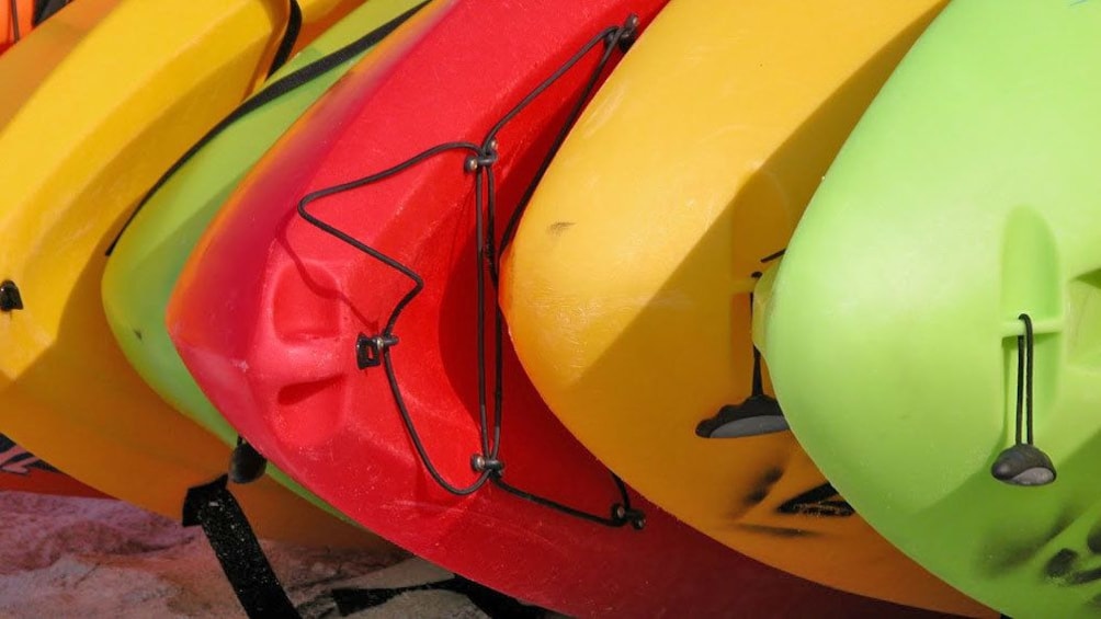 neatly stacked kayaks on the beach in Maui