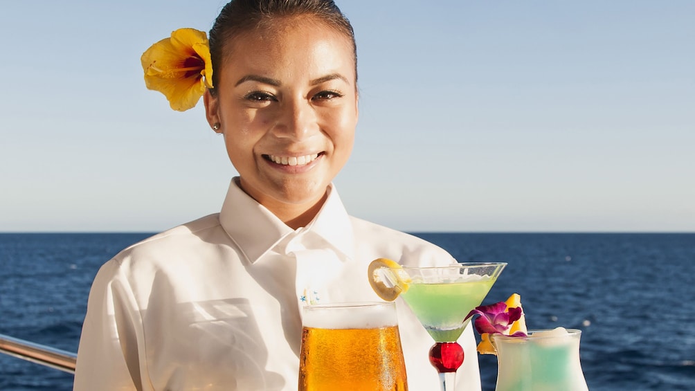 Server with drinks on Sunset Dinner Cruise 