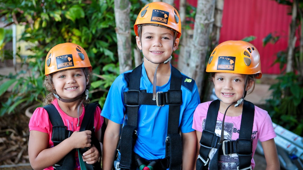 Three kids about to zipline in Maui
