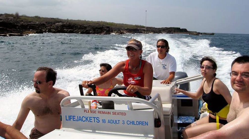 group riding on motor boat in the pacific ocean 