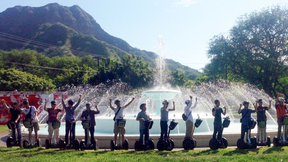 Adventurers celebrating at a water fountain at the conclusion of their segway tour