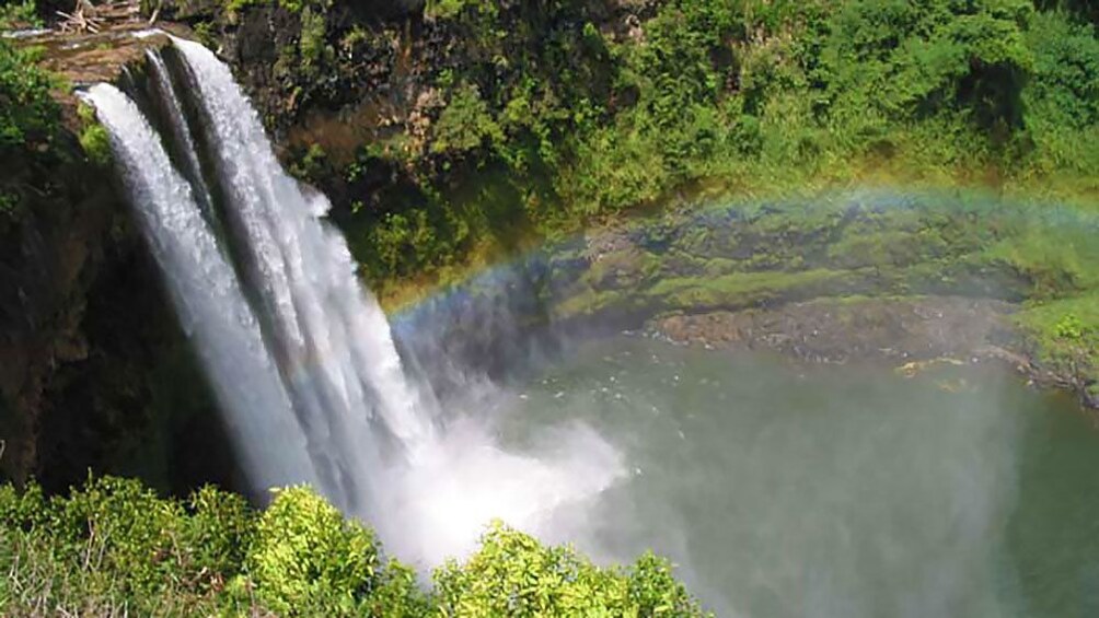 rainbow near a small waterfall in Kauai