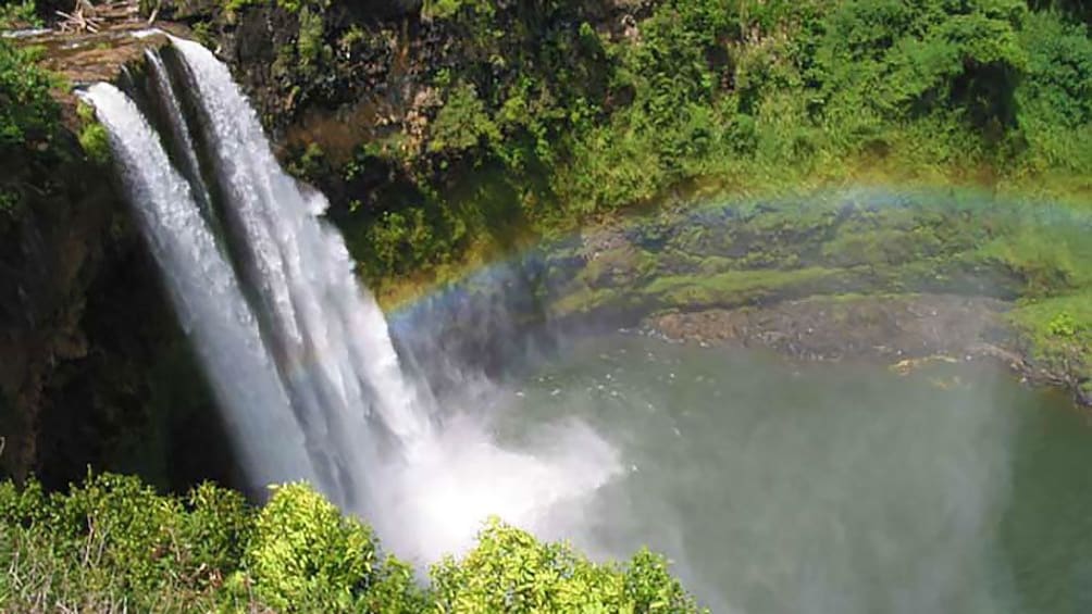 rainbow near a small waterfall in Kauai