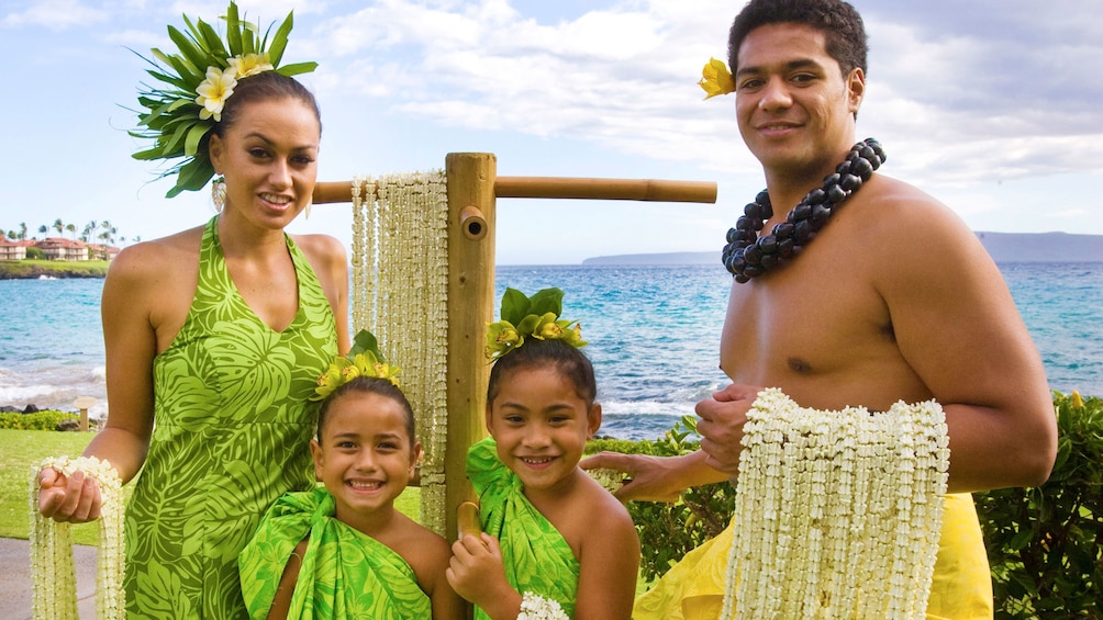 Couple with kids performing in the Te Au Moana Luau in Maui 