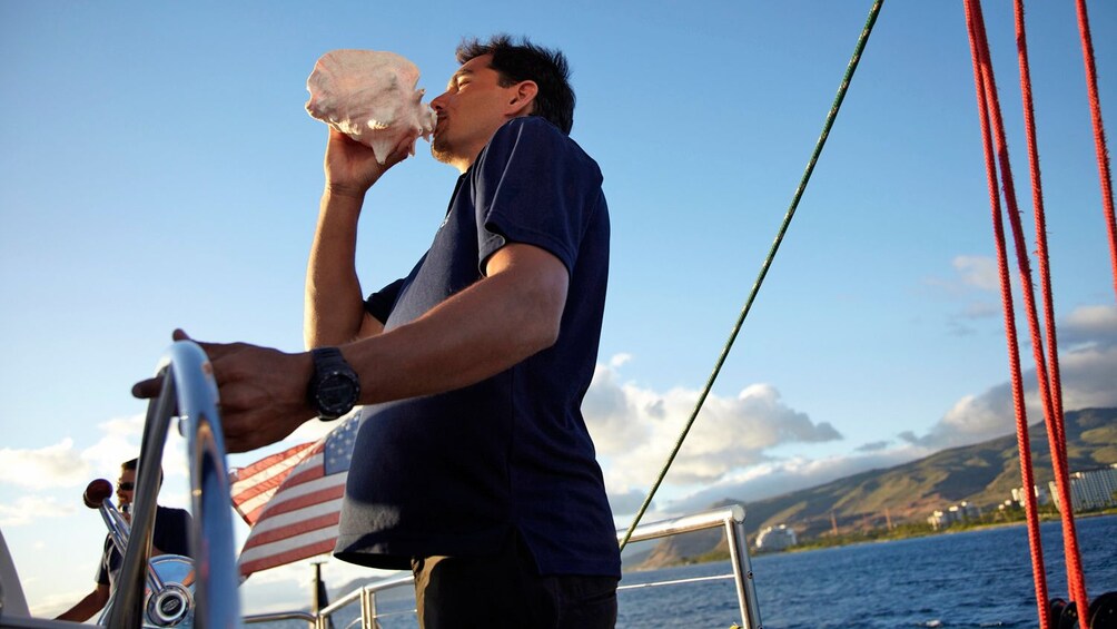 Man with conch shell in Oahu