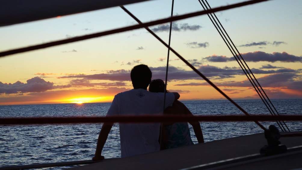 Couple enjoying sunset on boat