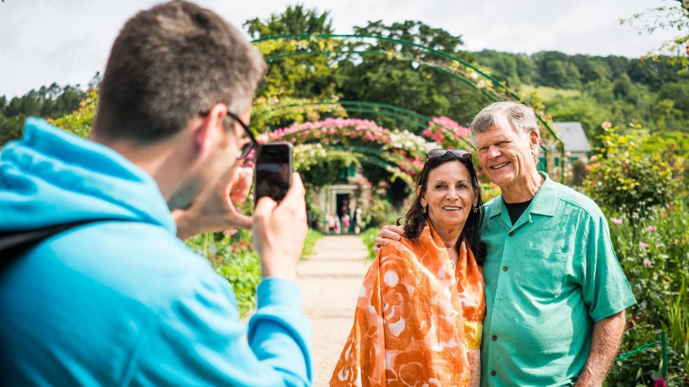 Couple having their picture taken in Monet’s Garden