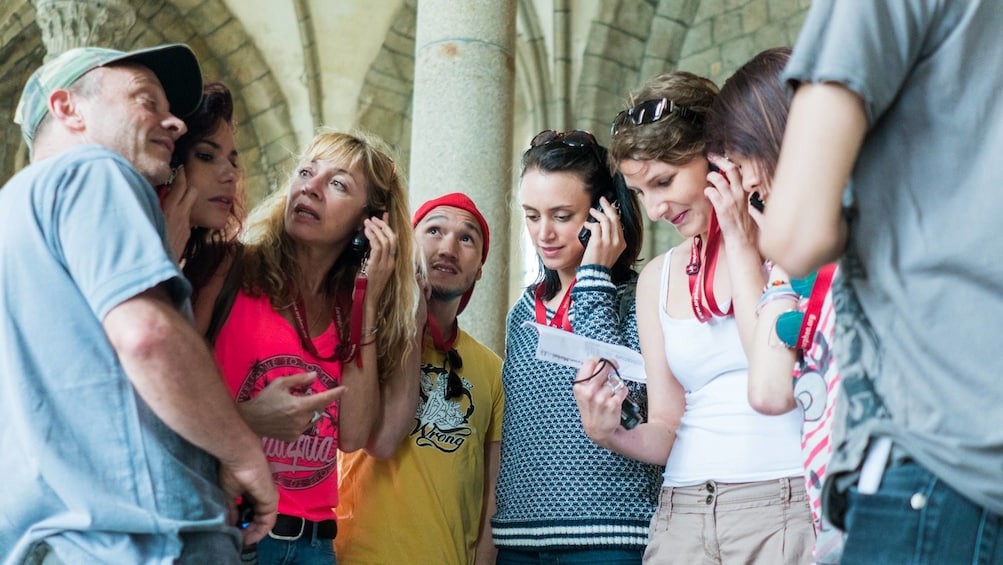 tour group listens to audio tour of Mont Saint-Michel Trip