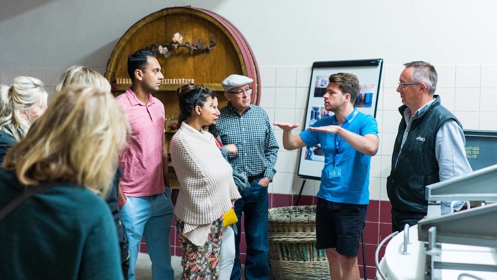  Moet & Chandon guide with tour-goers