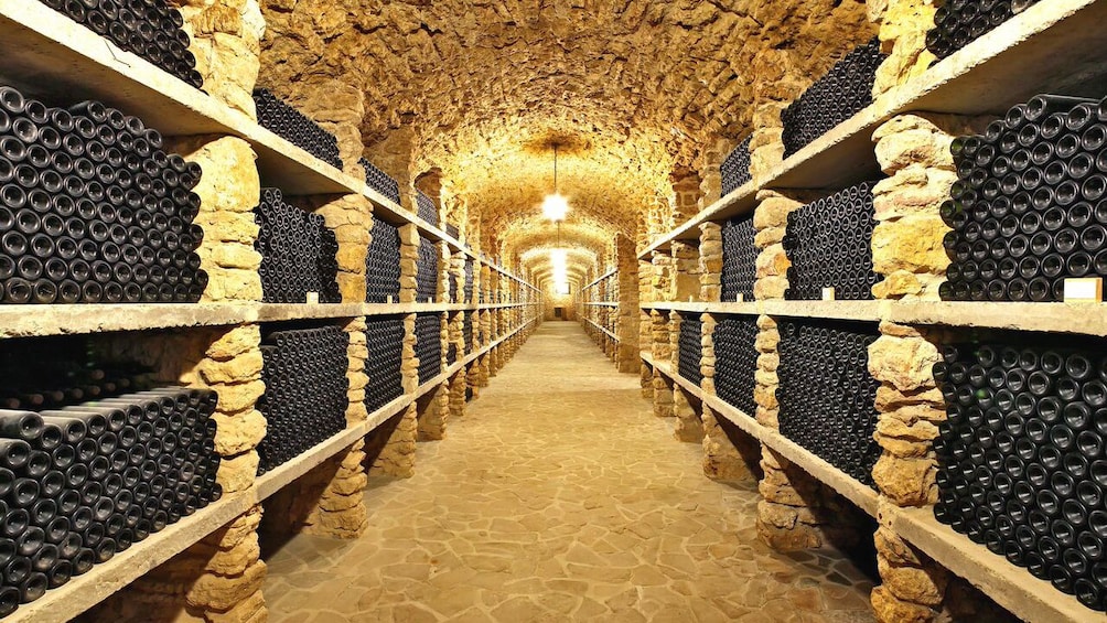 Interior view of wine cellar with rows of wine bottles 