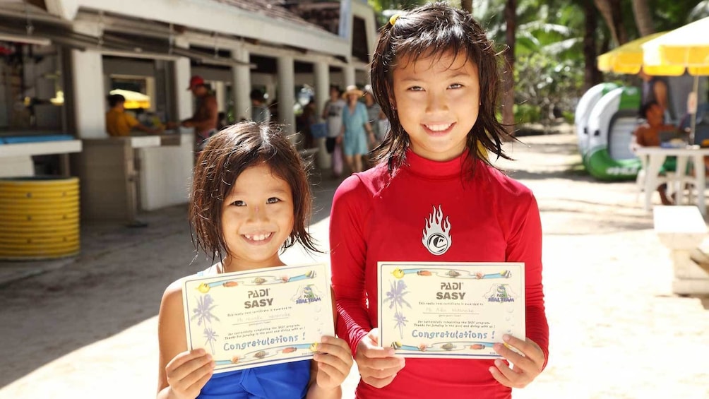 kids holding up certificates in Micronesia
