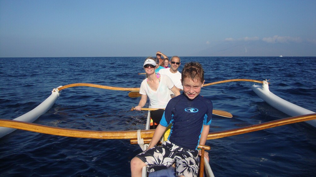 Family on an outrigger canoe on Maui