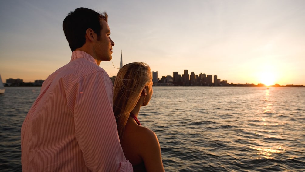 Couple observing sunset from boat.