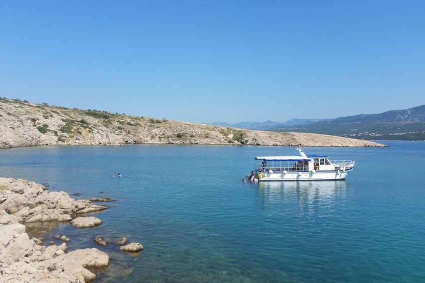 Boat and snorkelers in a calm bay