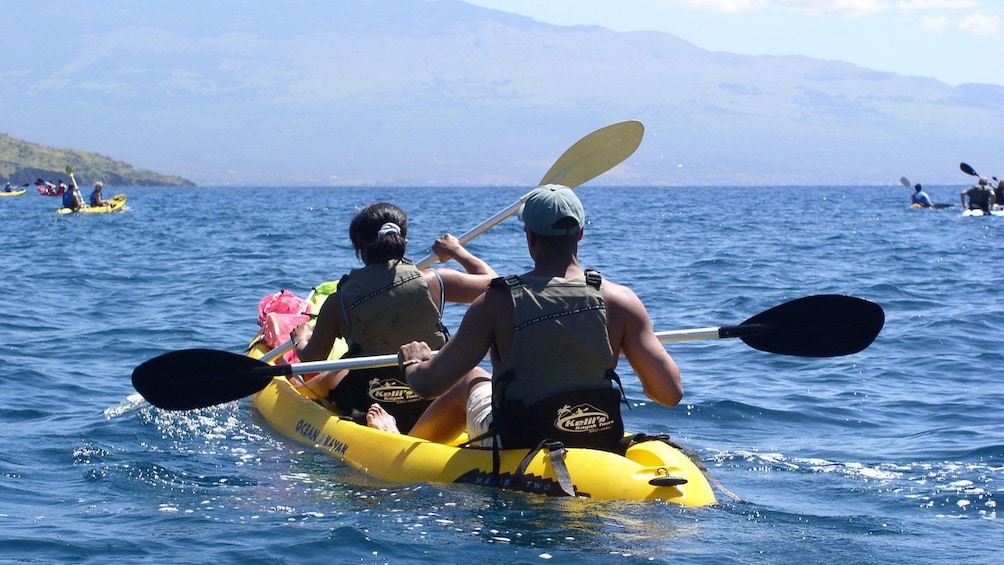 People in tandem kayak off of Maui