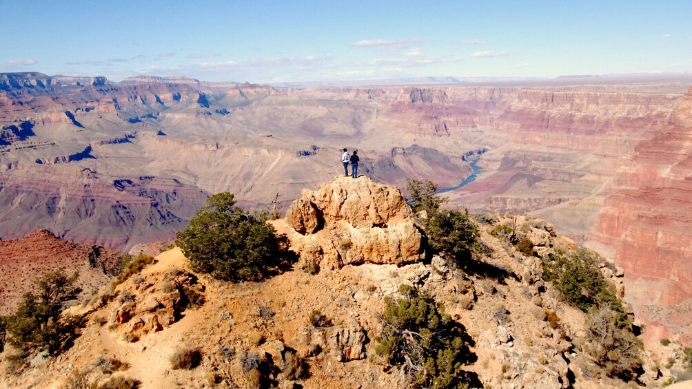Couple enjoying panoramic views of the Grand Canyon South Rim