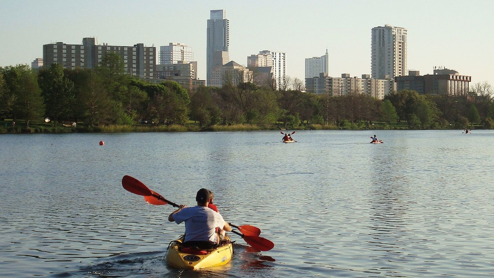 Kayakers paddling through river in Austin