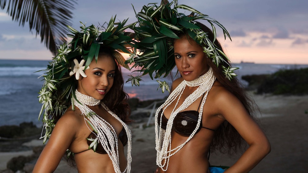 Luau performers on beach with head dresses