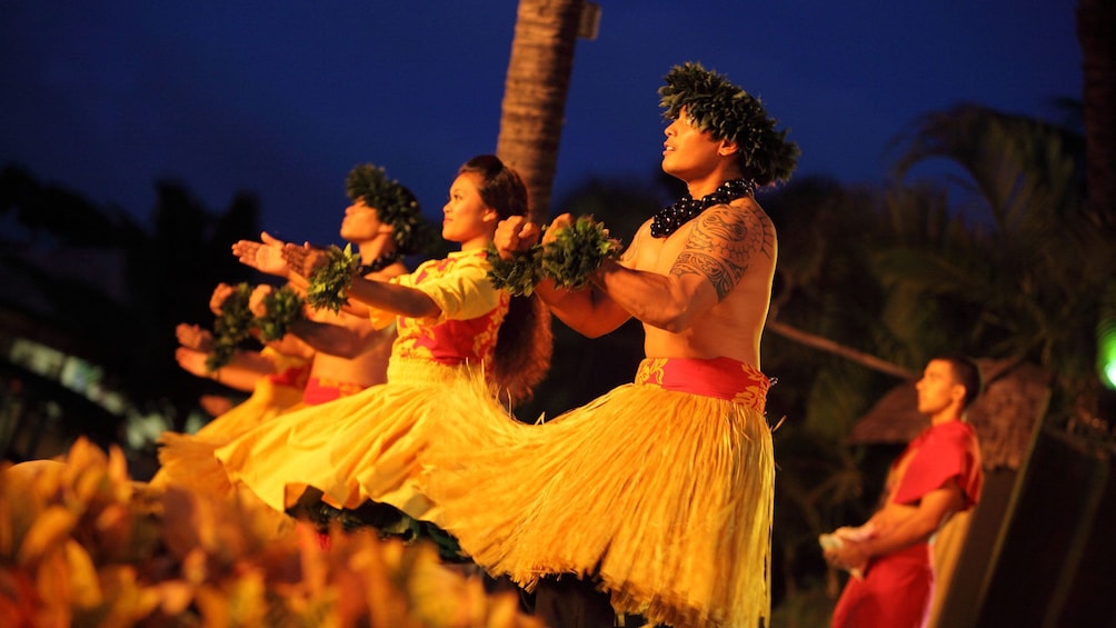 Luau performers in grass skirts