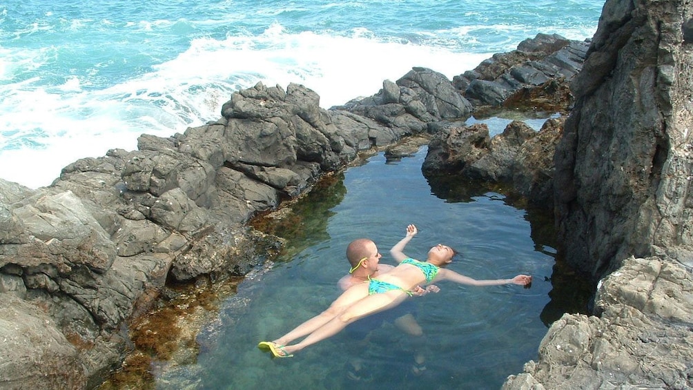 Show item 5 of 6. Woman floating in the water in Oahu